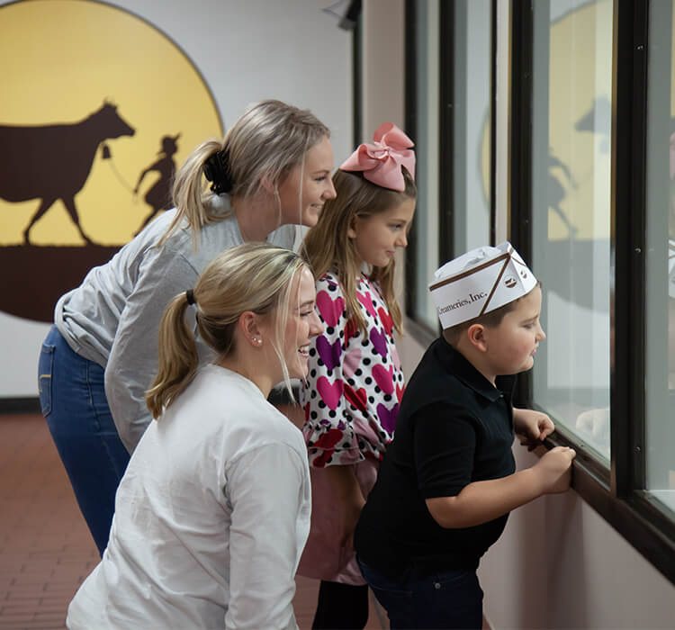 Observation deck in Brenham Children with tour guides looking thru windows of observation deck